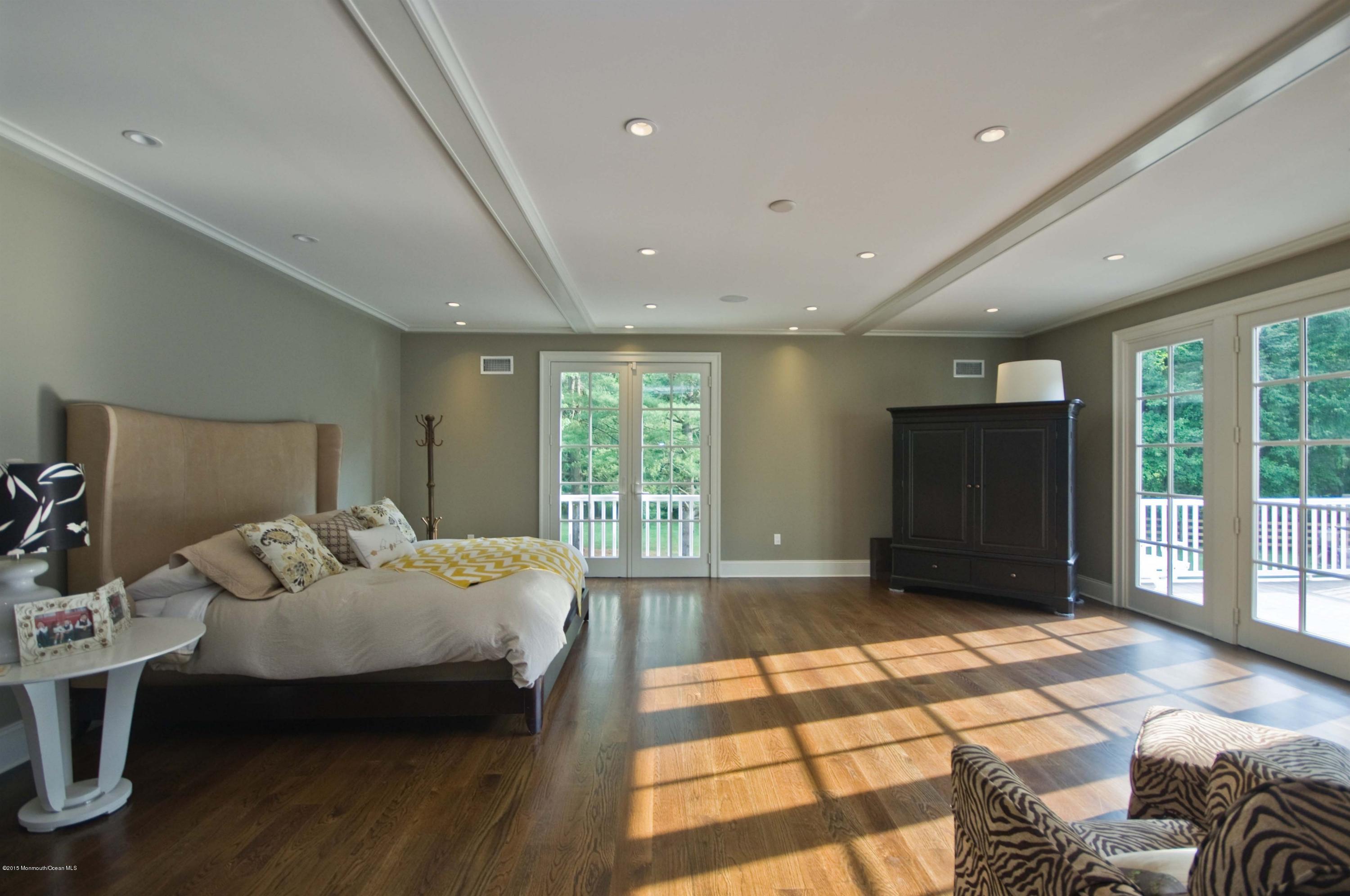51 Phalanx Road Colts Neck, NJ 07722 - Photo 13 of 35 a spacious bedroom with a bed and a large window
