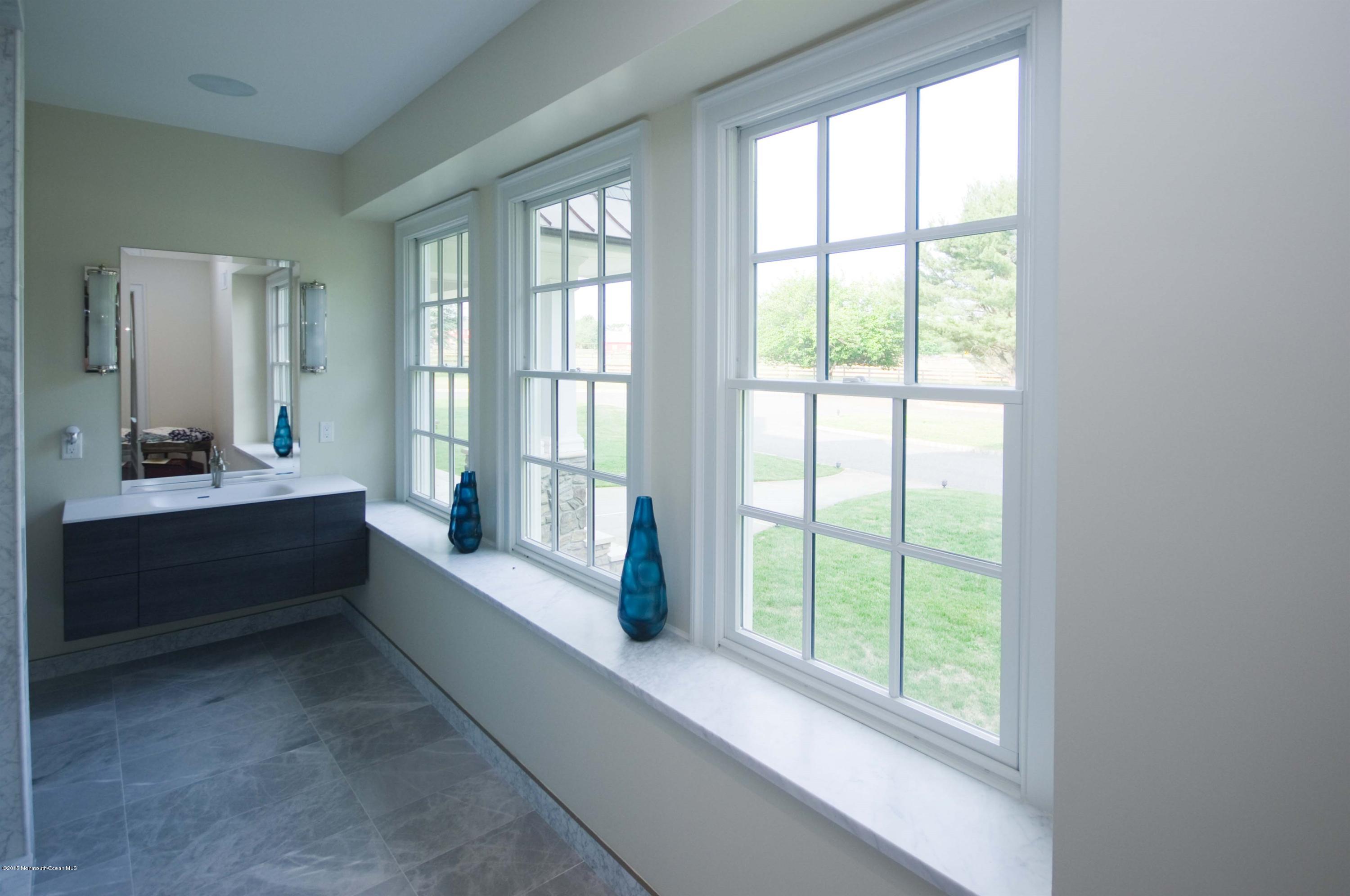 51 Phalanx Road Colts Neck, NJ 07722 - Photo 16 of 35 a bathroom with a double vanity sink and tub