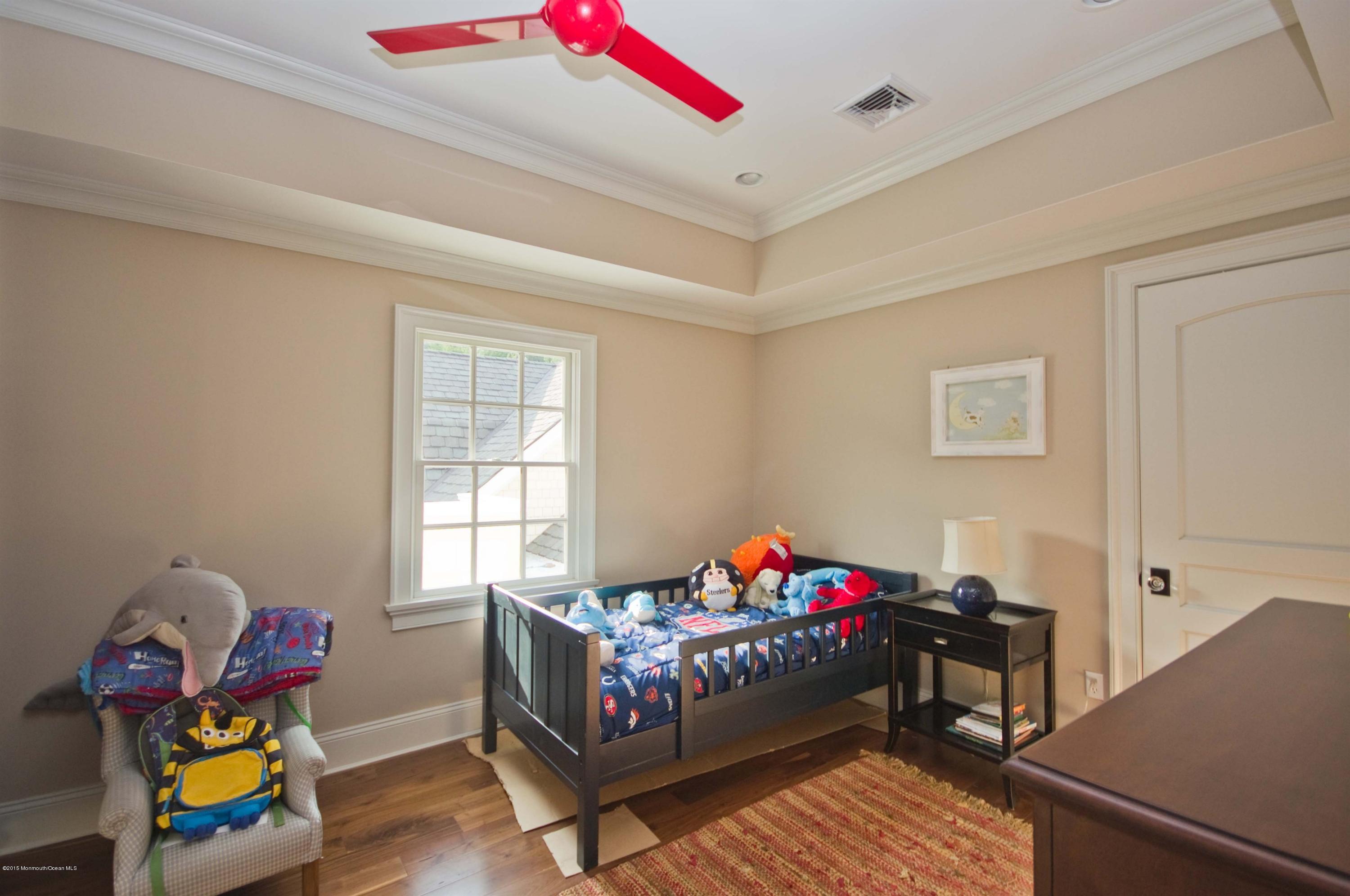 51 Phalanx Road Colts Neck, NJ 07722 - Photo 18 of 35 a bedroom with furniture and a window