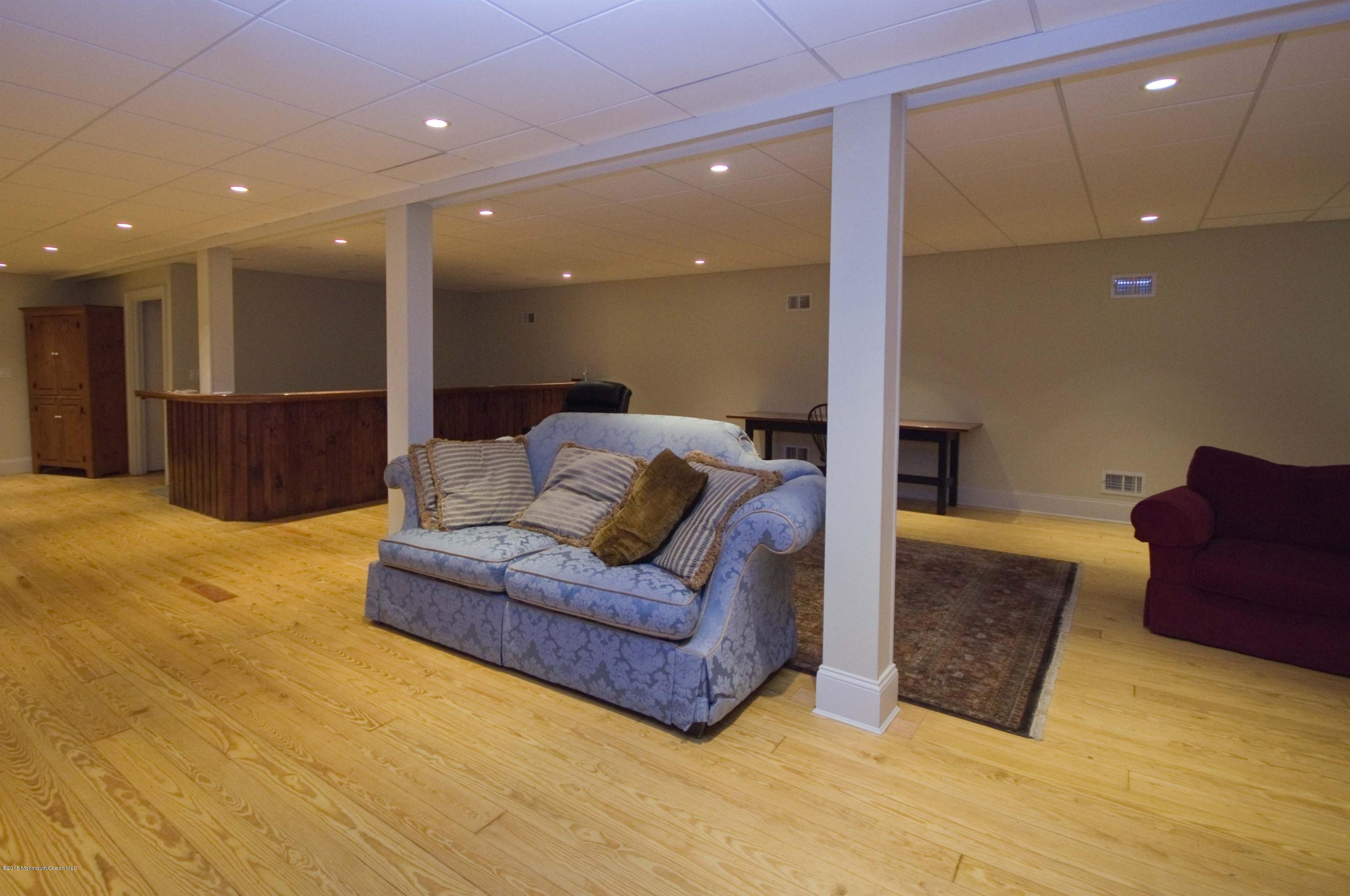 51 Phalanx Road Colts Neck, NJ 07722 - Photo 26 of 35 a living room with furniture and a mirror