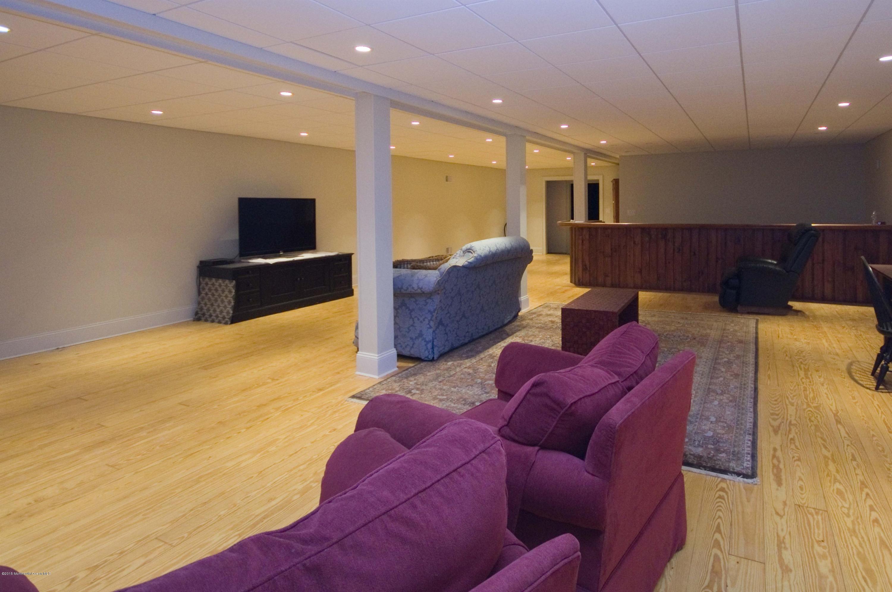 51 Phalanx Road Colts Neck, NJ 07722 - Photo 27 of 35 a living room with furniture and a flat screen tv