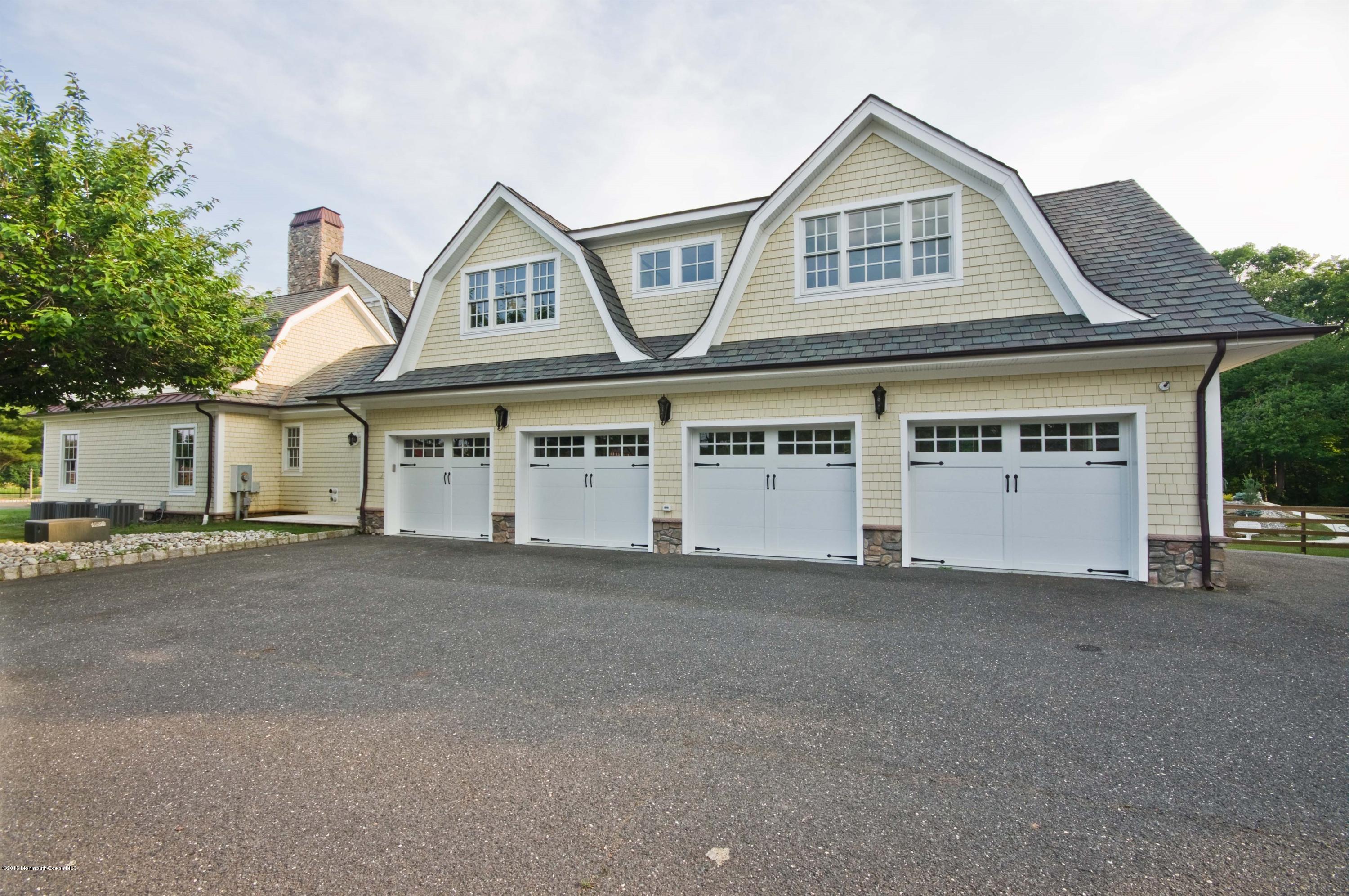 51 Phalanx Road Colts Neck, NJ 07722 - Photo 28 of 35 a front view of a house with a yard and garage