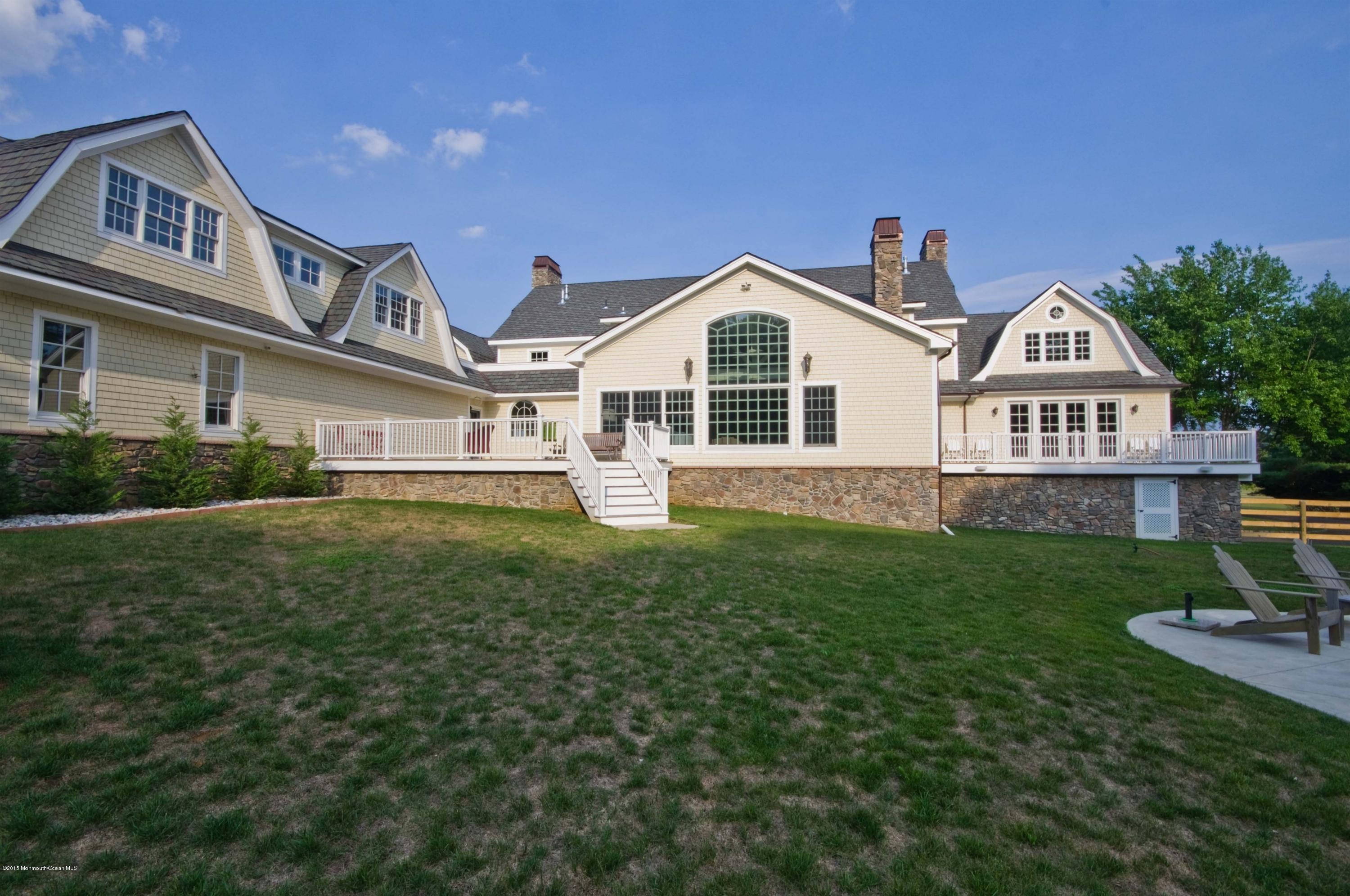 51 Phalanx Road Colts Neck, NJ 07722 - Photo 29 of 35 a front view of a house with a garden and plants