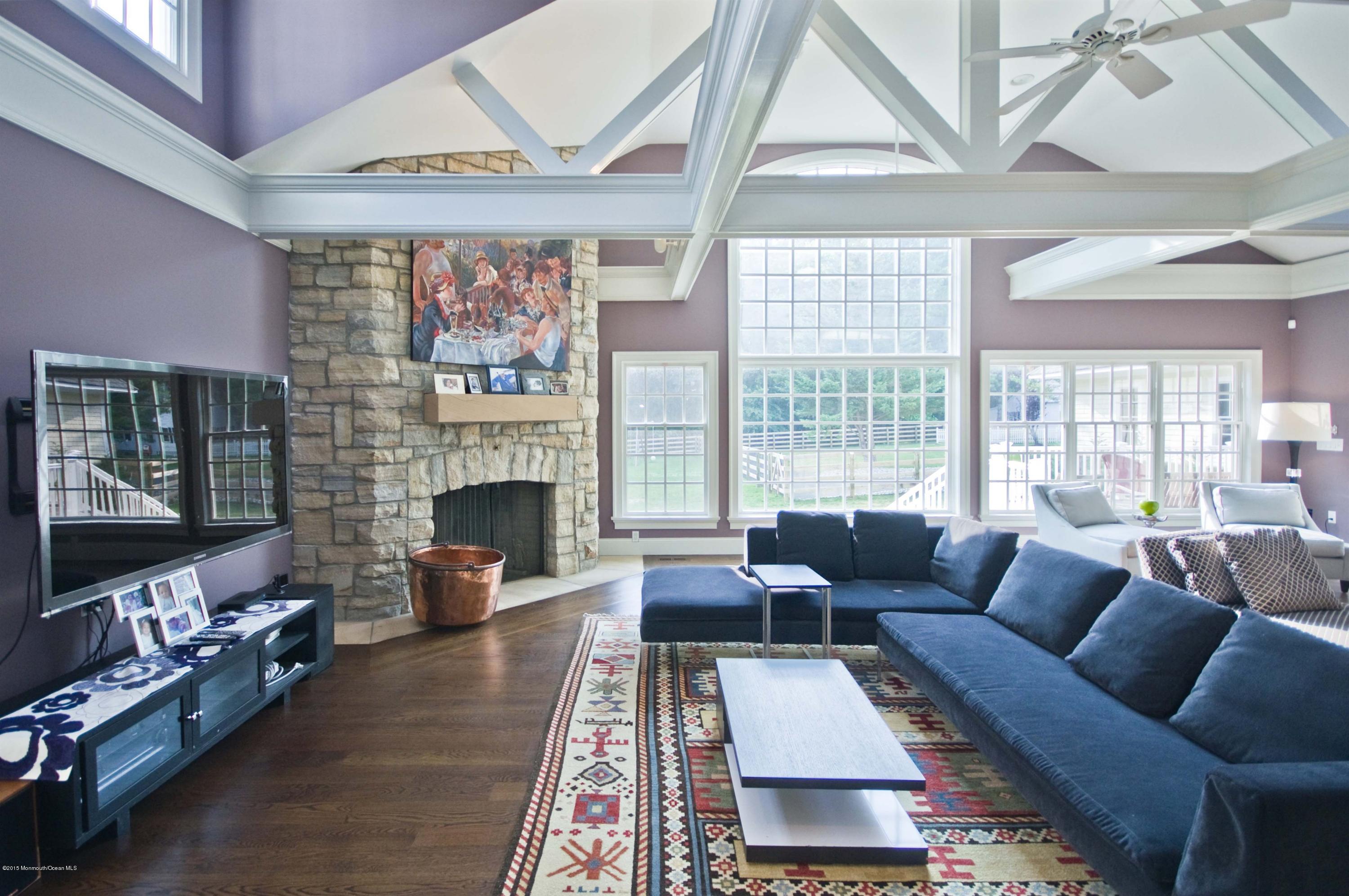 51 Phalanx Road Colts Neck, NJ 07722 - Photo 5 of 35 a living room with furniture a flat screen tv and a fireplace