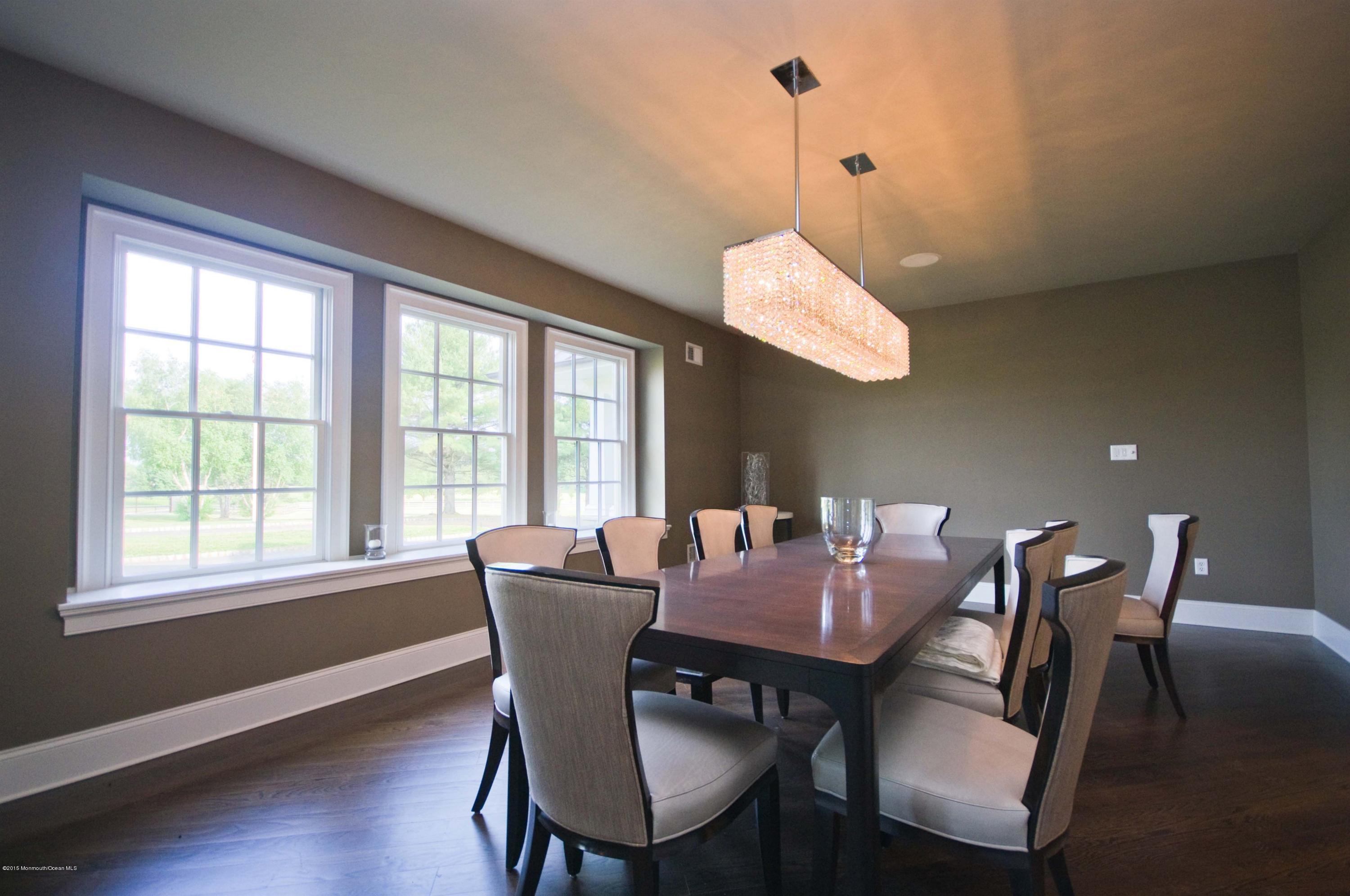 51 Phalanx Road Colts Neck, NJ 07722 - Photo 9 of 35 a dining room with furniture a chandelier and wooden floor