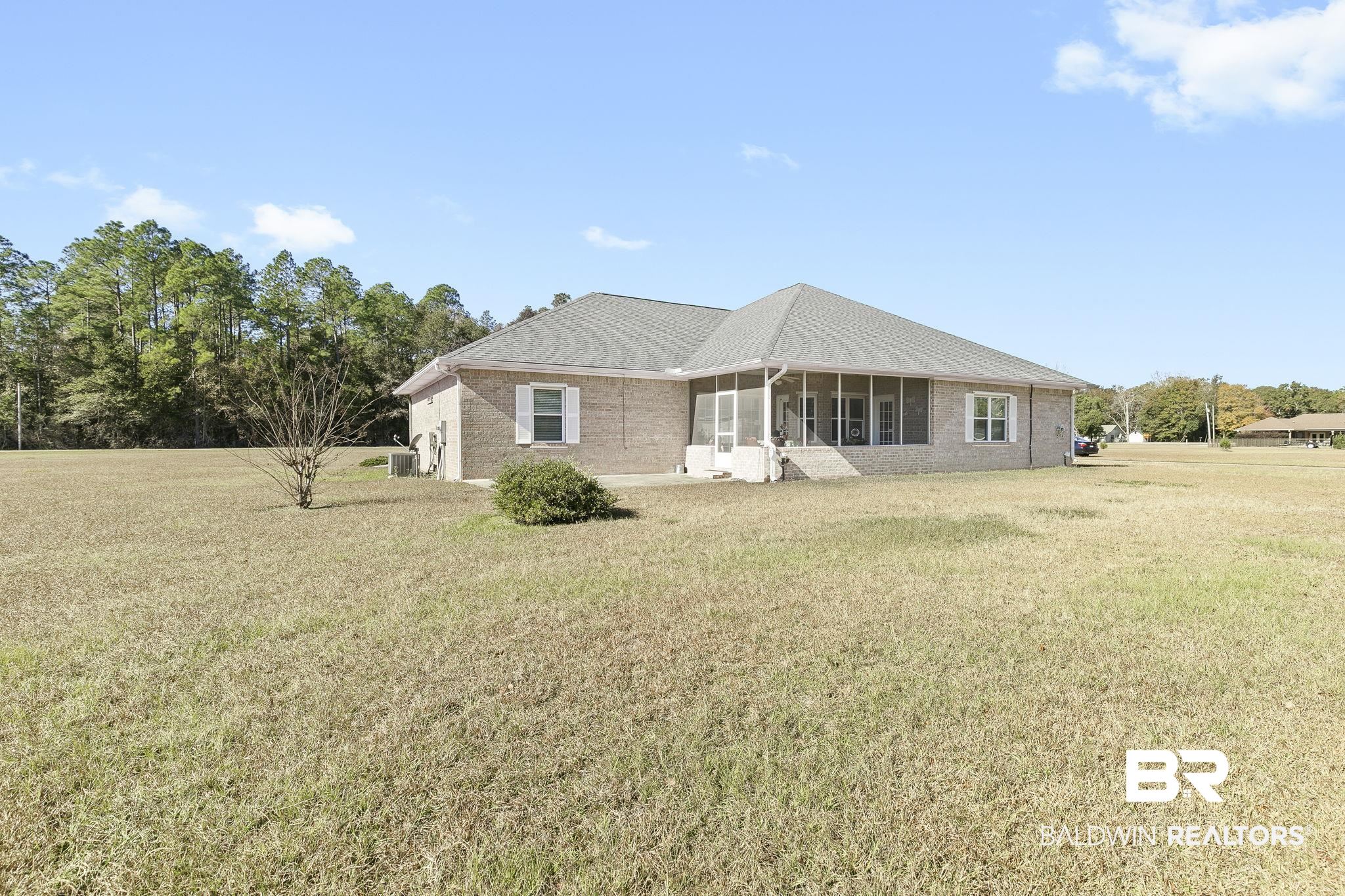 24130 Cowling Road Robertsdale, AL 36567 - Photo 47 of 71 Rear view of property with a sunroom and a lawn