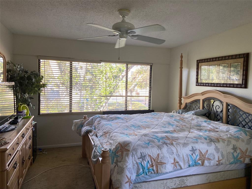 11450 Harbor Way, Unit 5002 Largo, FL 33774 - Photo 11 of 25 a bedroom with a bed and a window