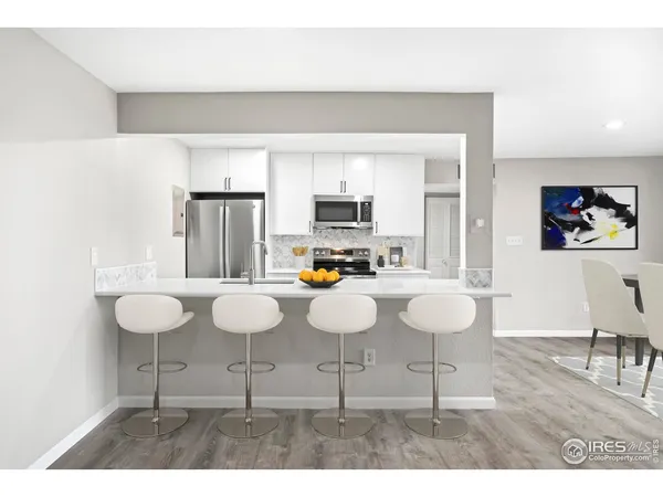 a dining room with furniture and wooden floor
