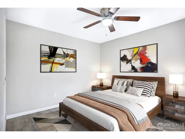 a bedroom with a bed and a painting on the wall