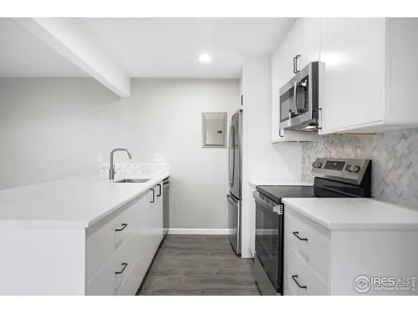 a kitchen with a sink a stove and refrigerator