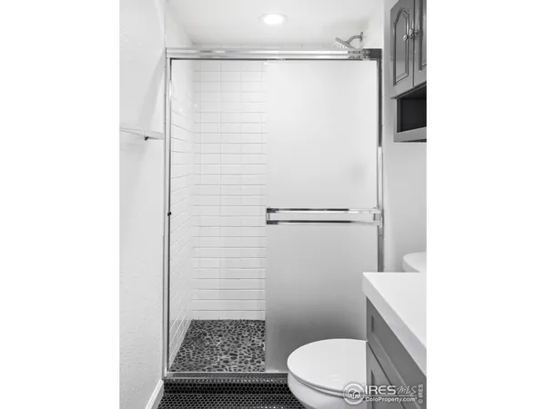 a bathroom with a toilet and a shower