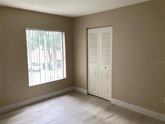 an empty room with wooden floor