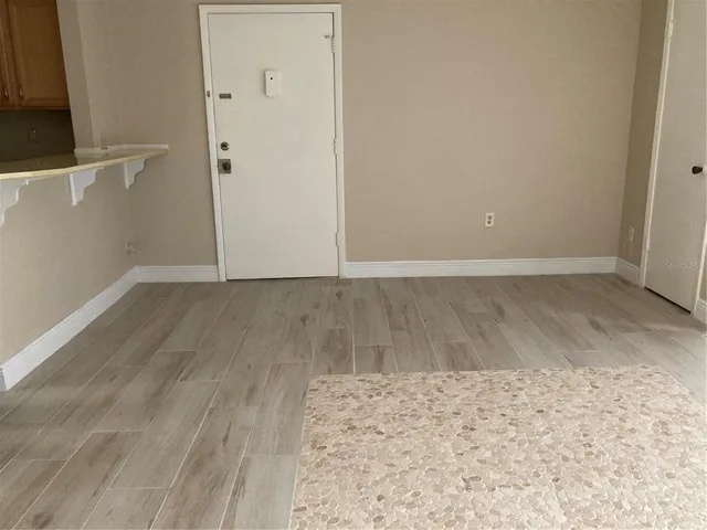 an empty room with wooden floor and a window