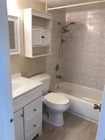 a bathroom with a toilet sink and shower