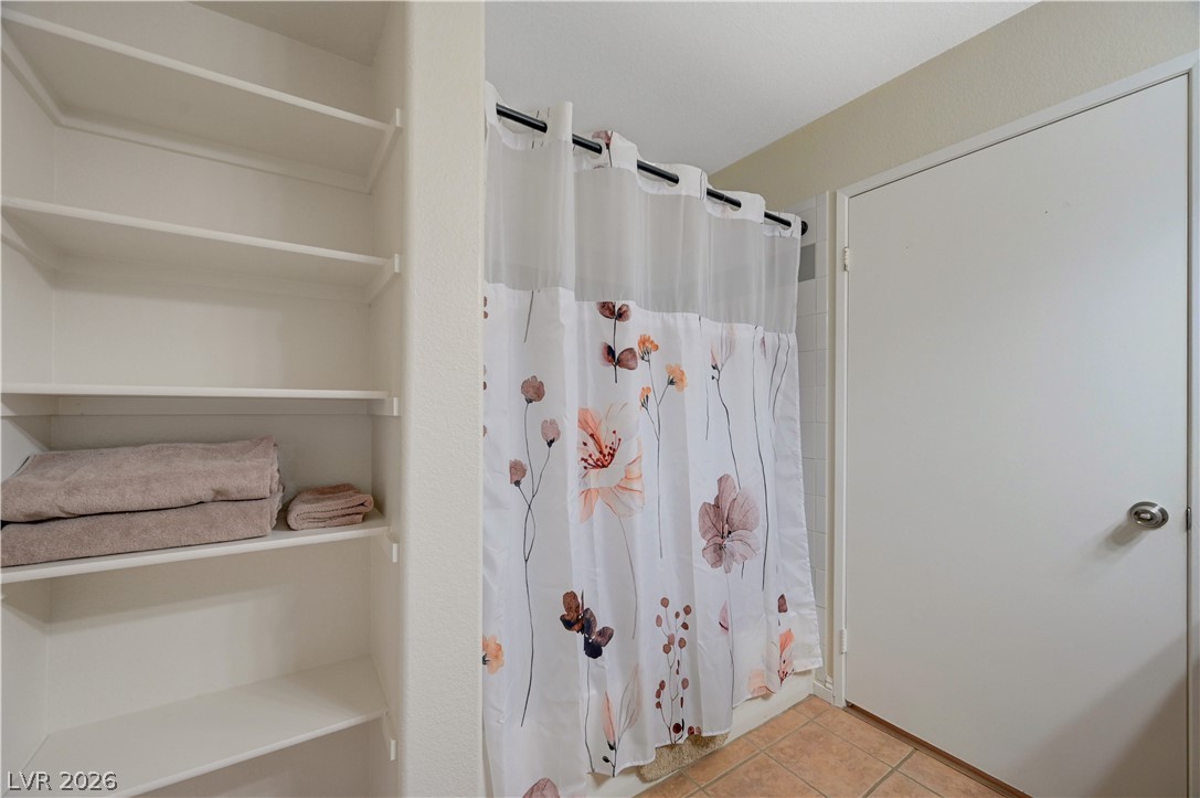 7885 West Flamingo Road, Unit 1071 Las Vegas, NV 89147 - Photo 16 of 28 Ample shelving in this bathroom provides practical storage solutions for everyday essentials.