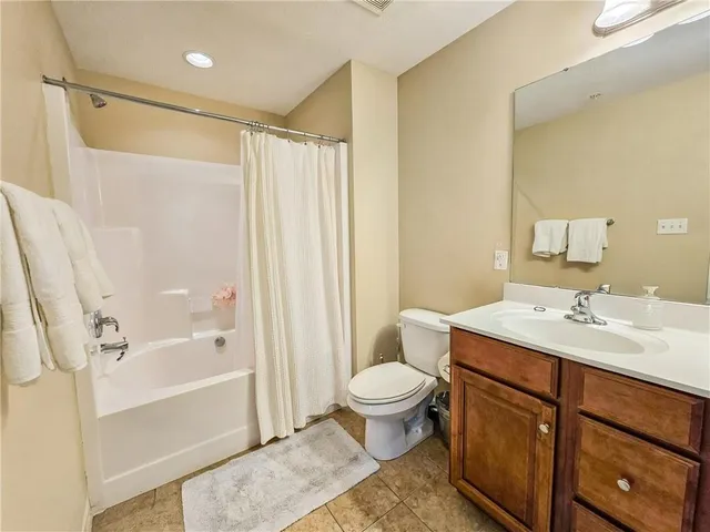 a bathroom with a sink toilet a mirror and shower