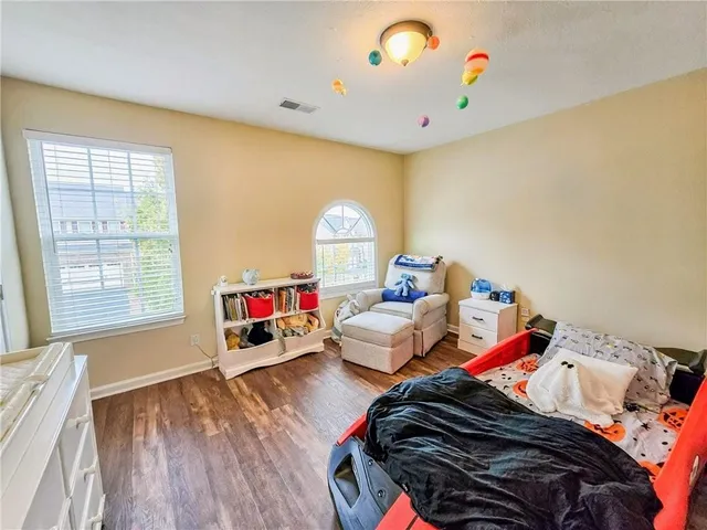 a bedroom with bed and a chandelier