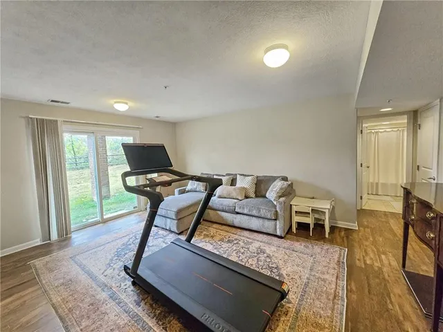 a living room with furniture rug and a table