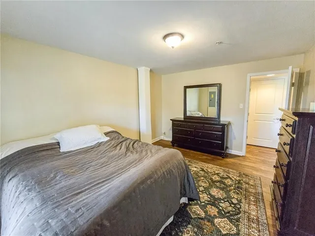 a bedroom with a bed and a dresser