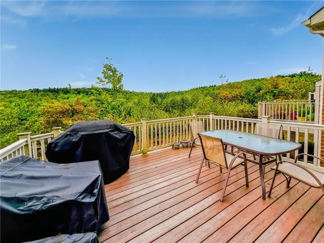 a view of a balcony with wooden floor and outdoor seating