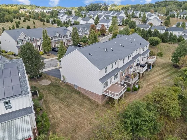 an aerial view of a house with outdoor space and street view