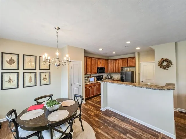 a kitchen with stainless steel appliances kitchen island granite countertop a sink and cabinets