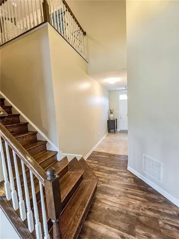 a view of an empty room and wooden floor