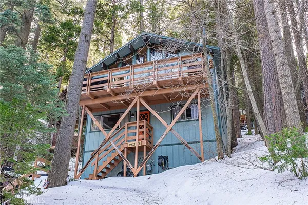 a view of a house with a wooden deck