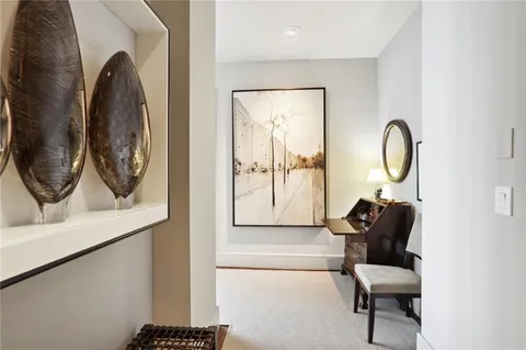 a living room with furniture and a painting on the wall