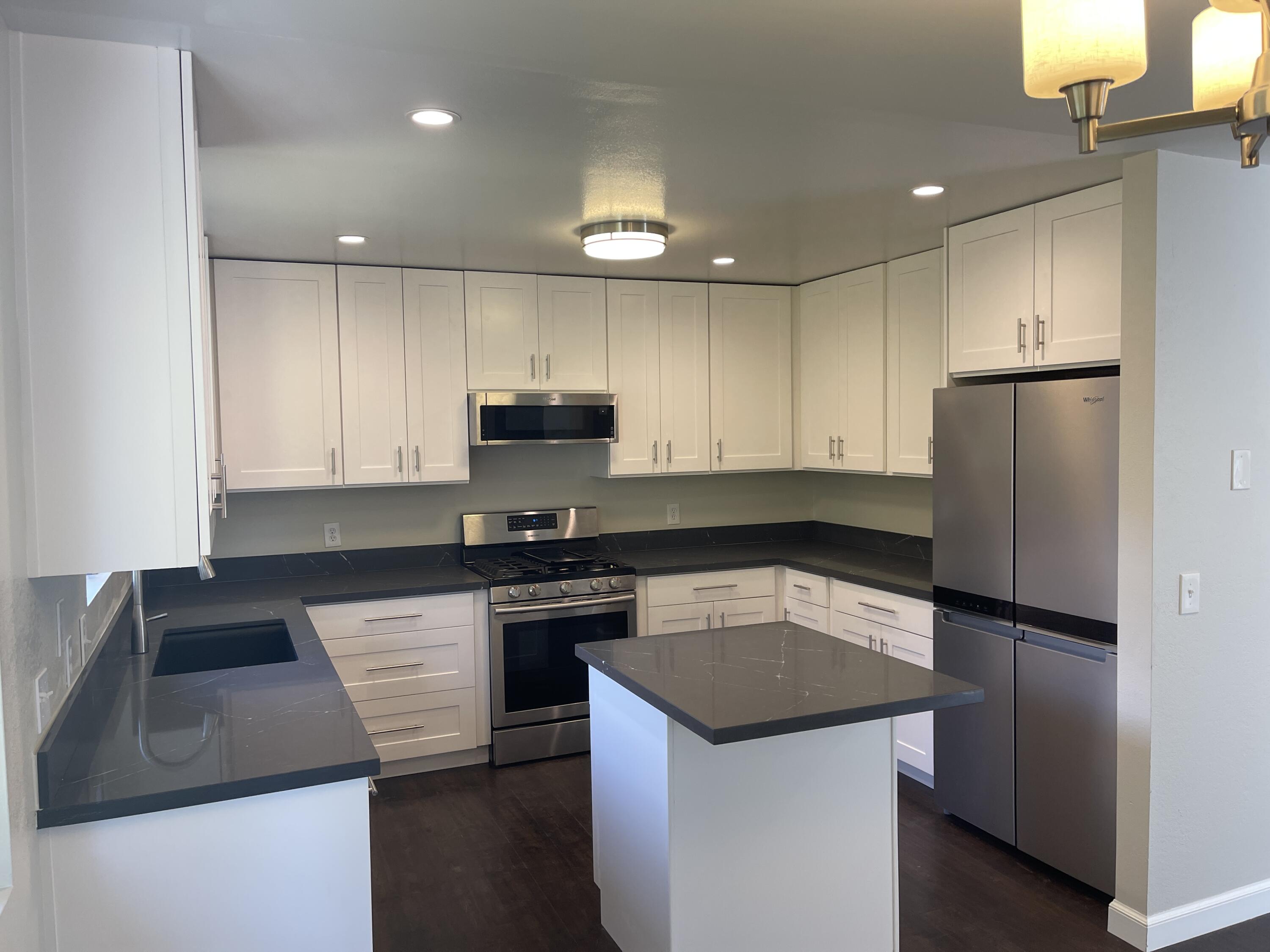 2019 Castillo Street Santa Barbara, CA 93105 - Photo 21 of 24 a kitchen with a sink a stove a refrigerator and cabinets