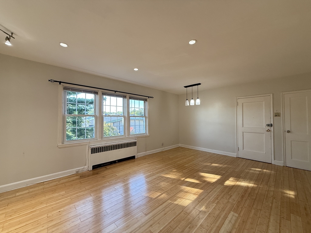 1 Dexter Street, Unit 5 Malden, MA 02148 - Photo 2 of 17 an empty room with wooden floor and windows