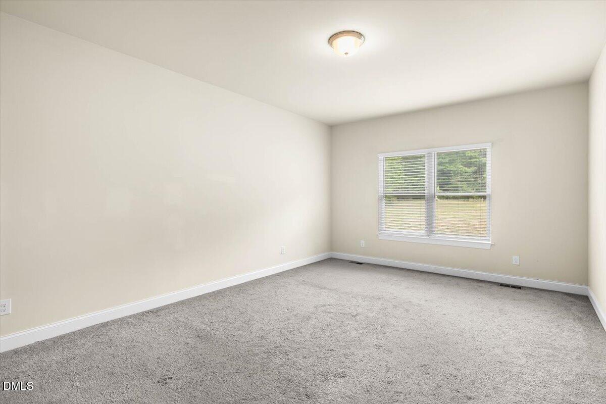 704 Haw River Hopedale Road Burlington, NC 27217 - Photo 21 of 49 an empty room with a window