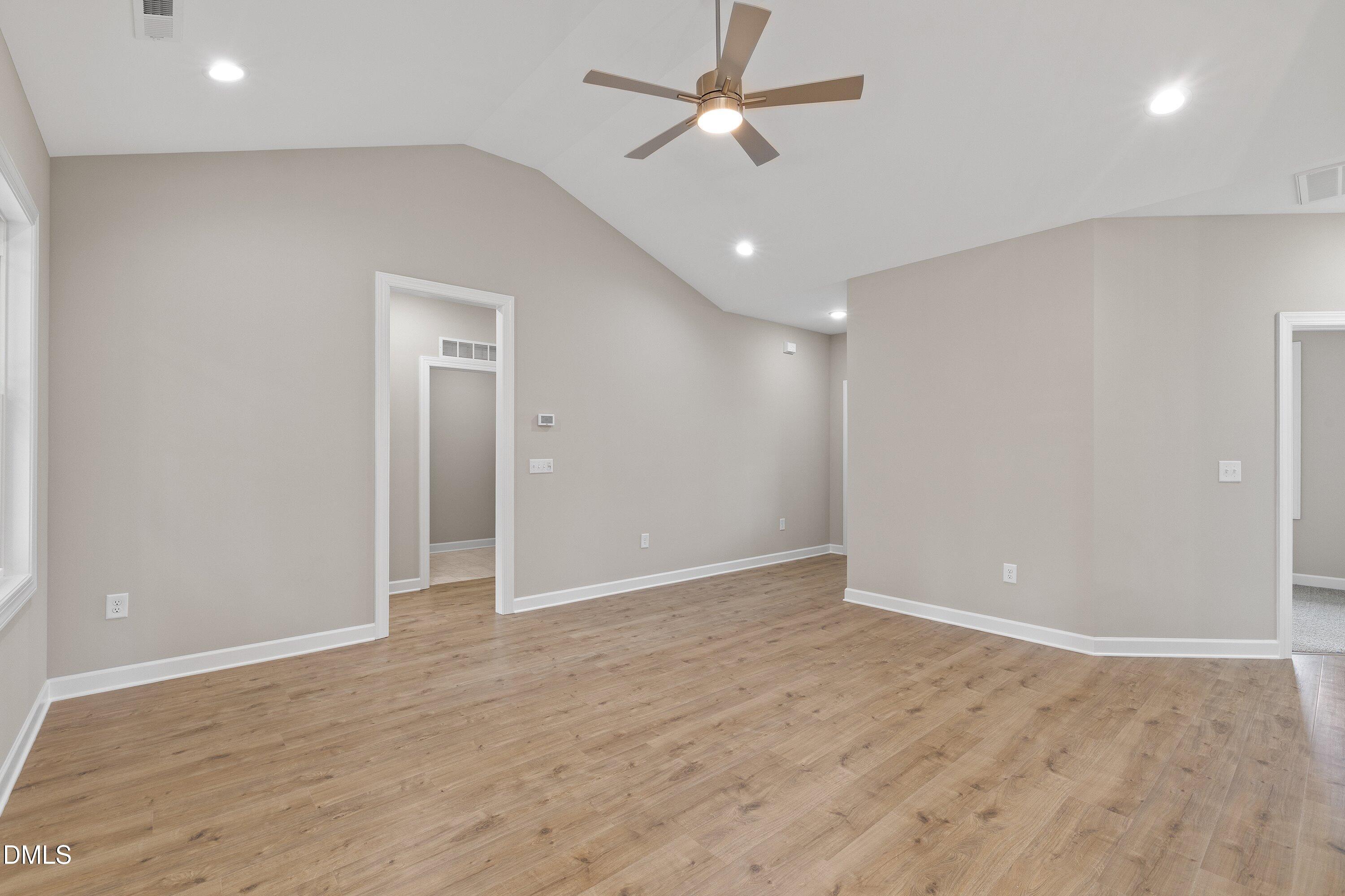 1115 Nor-Am Road Pikeville, NC 27863 - Photo 12 of 40 an empty room with wooden floor ceiling fan and window
