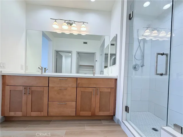 a view of a large mirror and cabinets