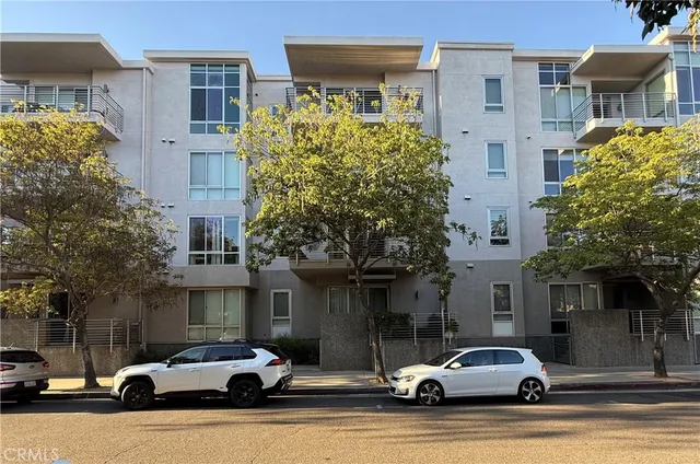 a car parked in front of white building