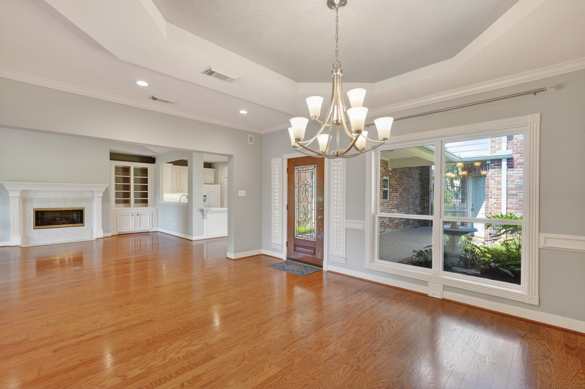 20714 Flora View Court Spring, TX 77379 - Photo 9 of 40 a view of a livingroom with a chandelier fireplace and wooden floor