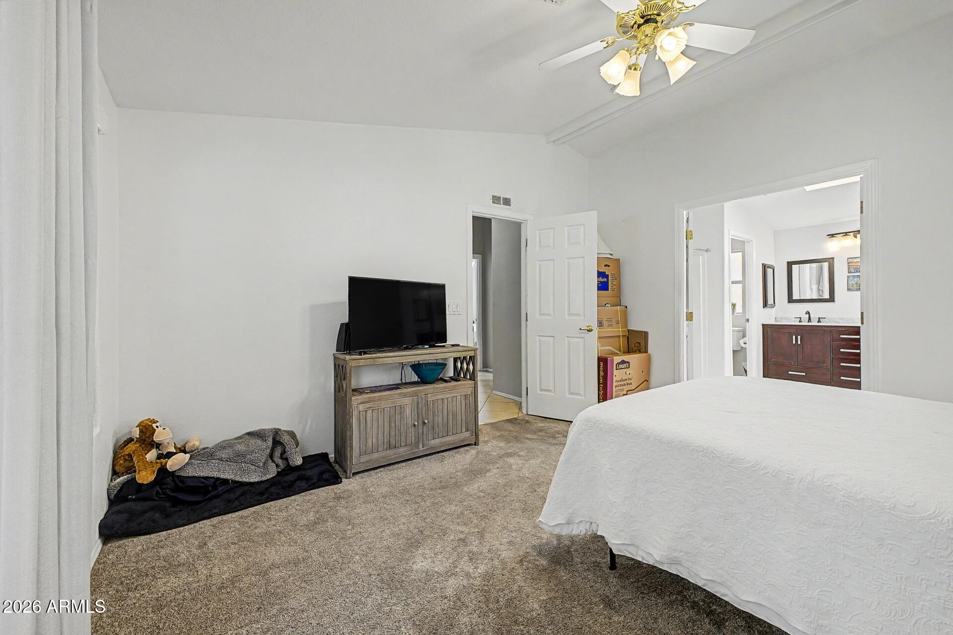 2550 South Ellsworth Road, Unit 46 Mesa, AZ 85209 - Photo 17 of 47 a bedroom with a bed and a flat screen tv