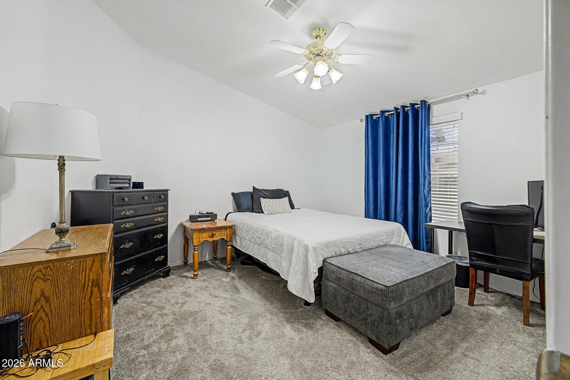 2550 South Ellsworth Road, Unit 46 Mesa, AZ 85209 - Photo 21 of 47 a bedroom with a bed and a chandelier