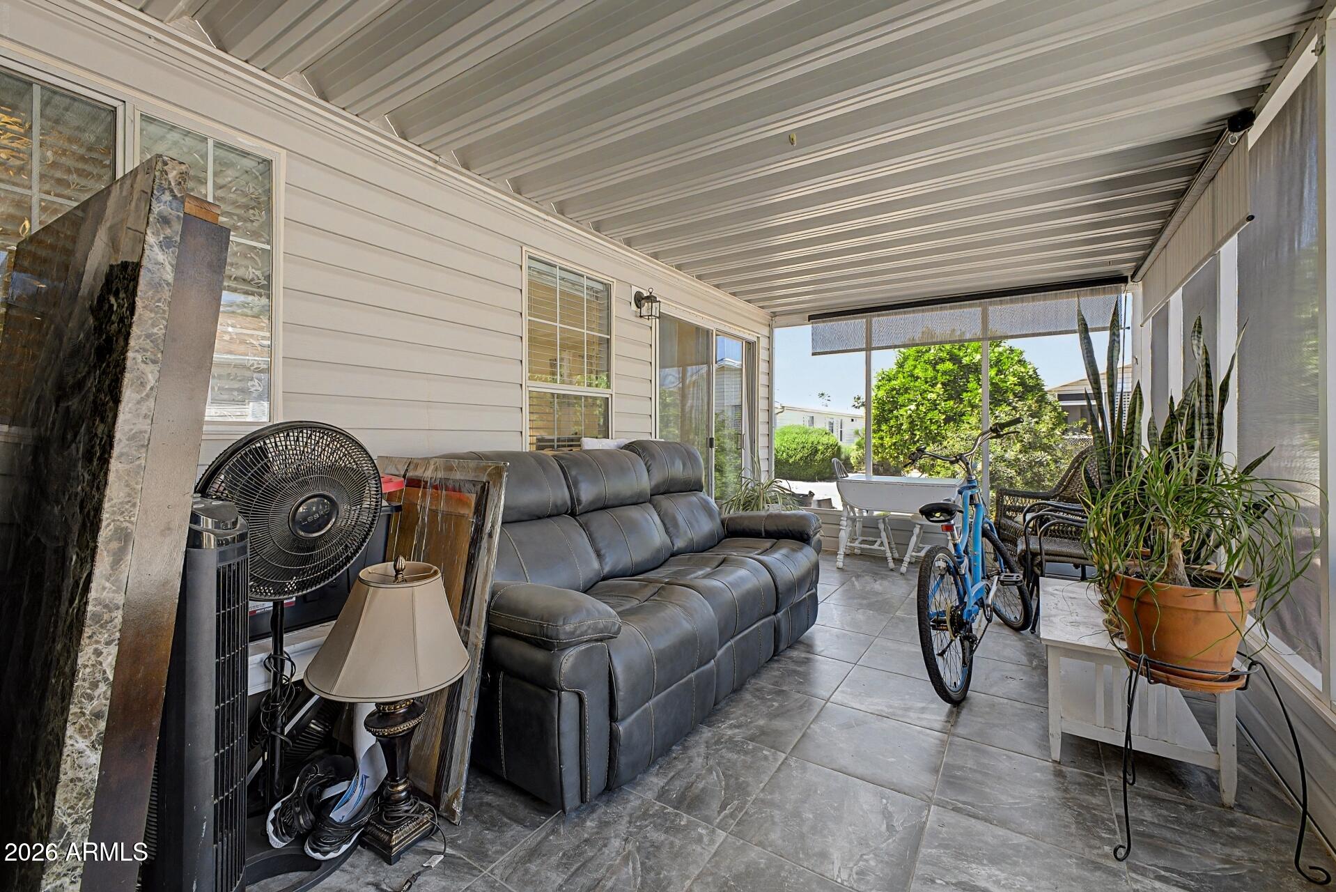 2550 South Ellsworth Road, Unit 46 Mesa, AZ 85209 - Photo 28 of 47 a living room with furniture a potted plant and a large window