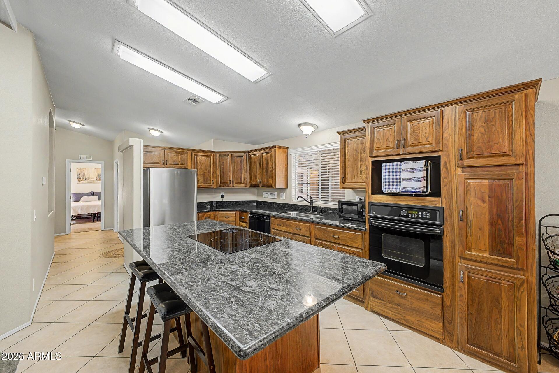 2550 South Ellsworth Road, Unit 46 Mesa, AZ 85209 - Photo 7 of 47 a kitchen with stainless steel appliances granite countertop a refrigerator stove and oven