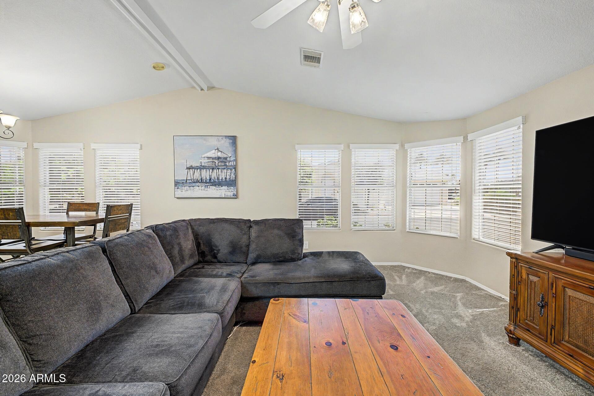 2550 South Ellsworth Road, Unit 46 Mesa, AZ 85209 - Photo 9 of 47 a living room with furniture flat screen tv and a large window