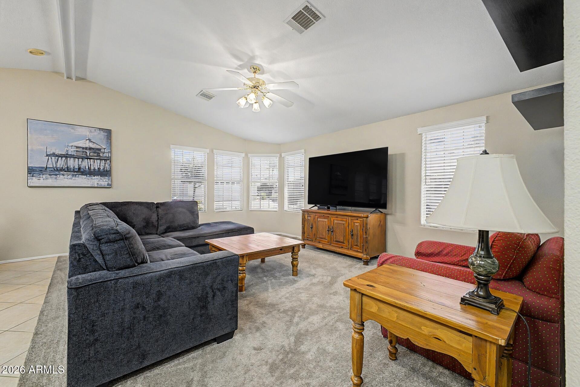 2550 South Ellsworth Road, Unit 46 Mesa, AZ 85209 - Photo 10 of 47 a living room with furniture and a flat screen tv