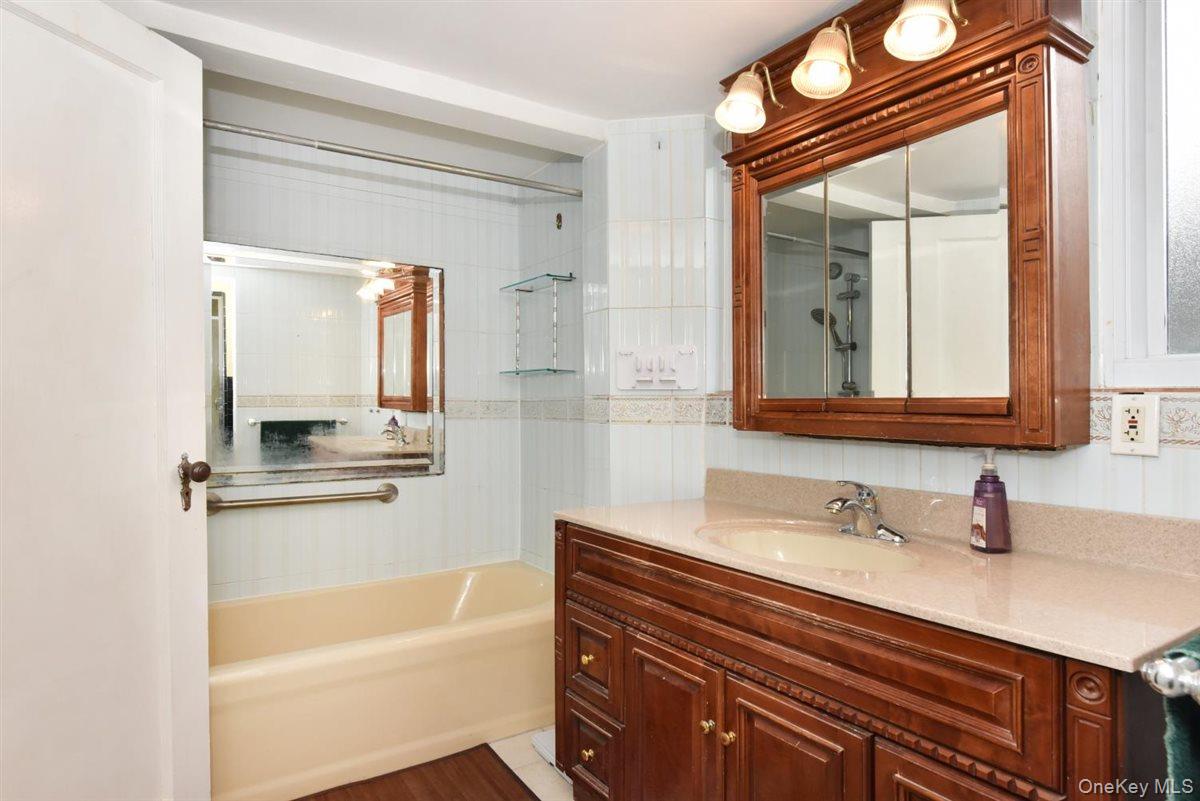 139-30 Coolidge Avenue Queens, NY 11435 - Photo 19 of 34 Full bath featuring vanity and tiled shower / bath combo