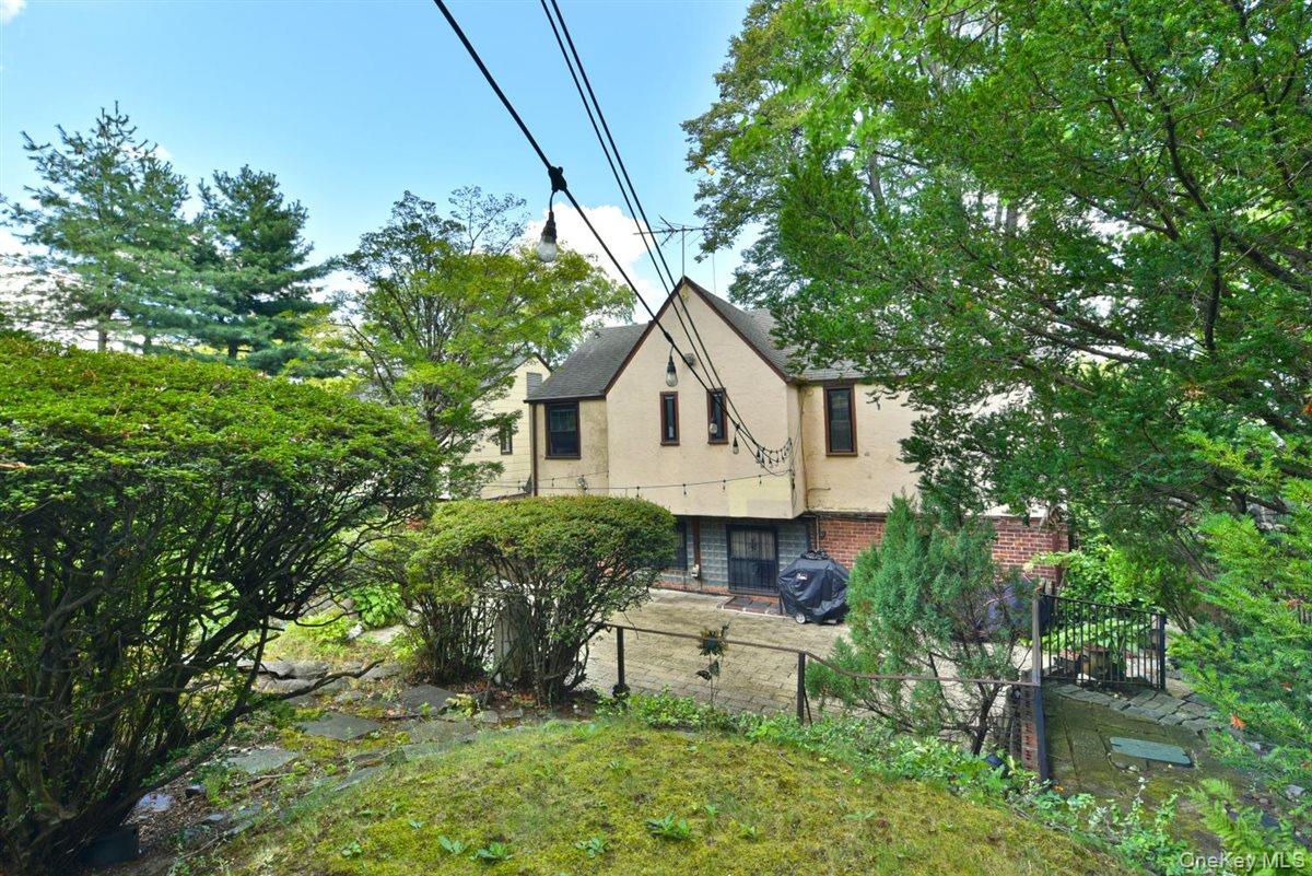 139-30 Coolidge Avenue Queens, NY 11435 - Photo 26 of 34 Rear view of property with brick siding, a fenced front yard, and stucco siding