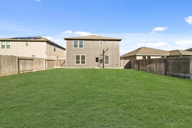 a front view of a house with a garden and yard