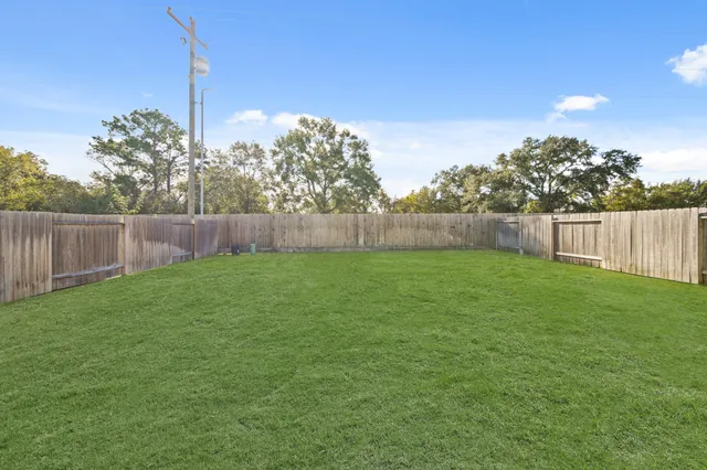 a view of yard with swimming pool and green space