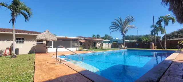 a view of a backyard with swimming pool