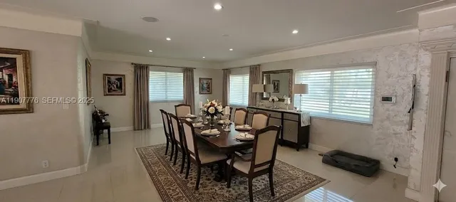 a view of a a dining room with furniture window and wooden floor