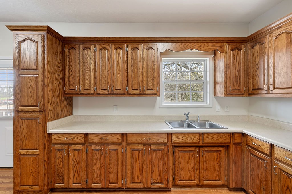 137 Piney Road Lawrenceburg, TN 38464 - Photo 13 of 33 a kitchen with stainless steel appliances granite countertop a refrigerator and cabinets