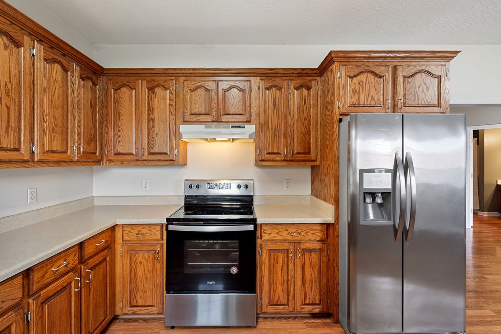 137 Piney Road Lawrenceburg, TN 38464 - Photo 14 of 33 a kitchen with stainless steel appliances granite countertop a refrigerator and a stove top oven